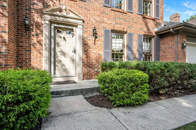 a view of a brick house with potted plants