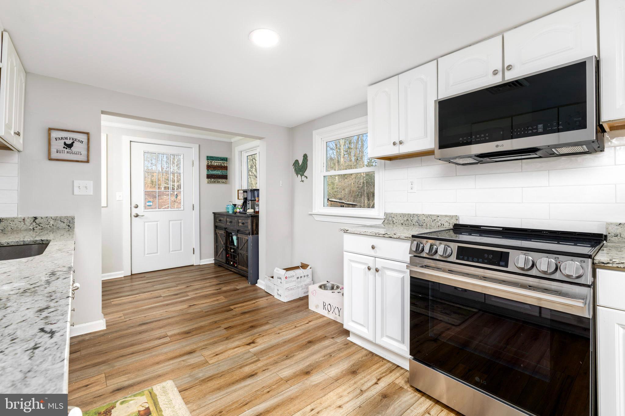 1052 South Hill Road Brodnax, VA 23920 - Photo 14 of 100 a kitchen with a stove and a microwave