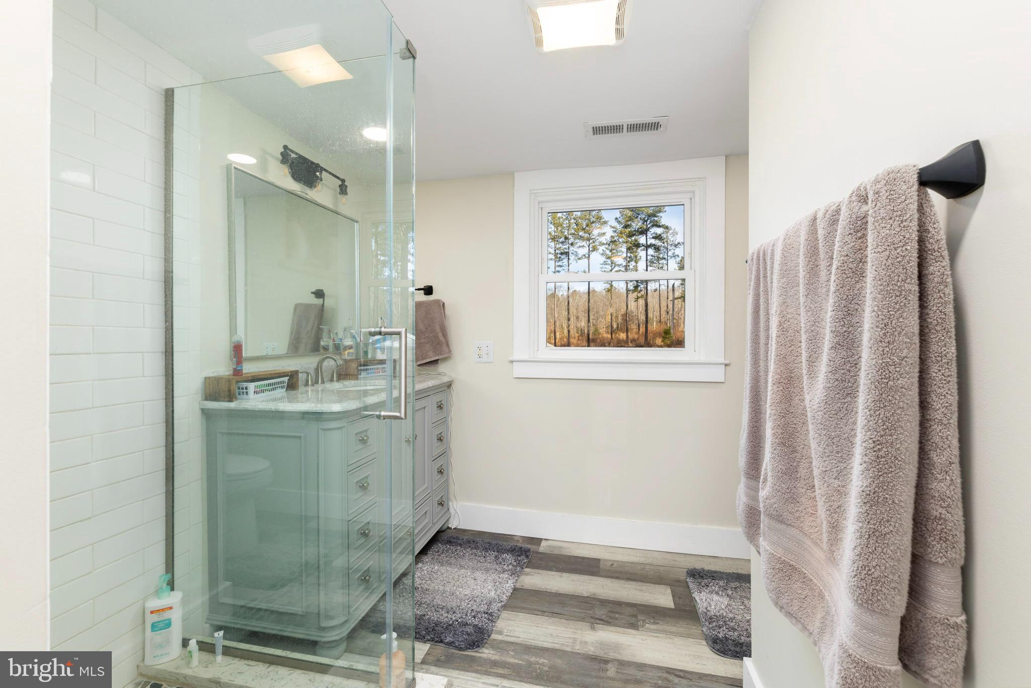 1052 South Hill Road Brodnax, VA 23920 - Photo 32 of 100 a bathroom with a granite countertop sink and a mirror