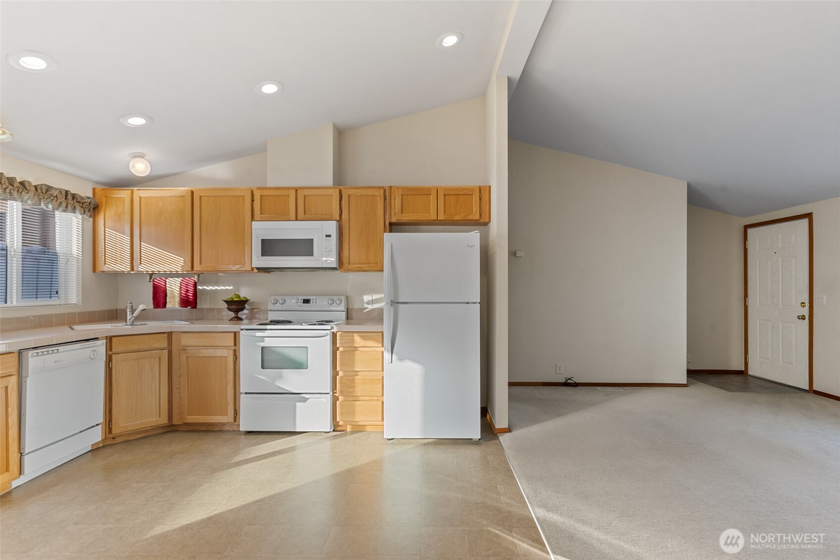 1232 Woods Street Wenatchee, WA 98801 - Photo 17 of 31 a kitchen with sink a refrigerator and white cabinets