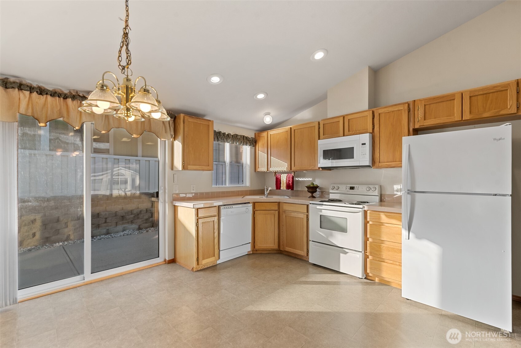 1232 Woods Street Wenatchee, WA 98801 - Photo 18 of 31 a kitchen with refrigerator a sink and dishwasher