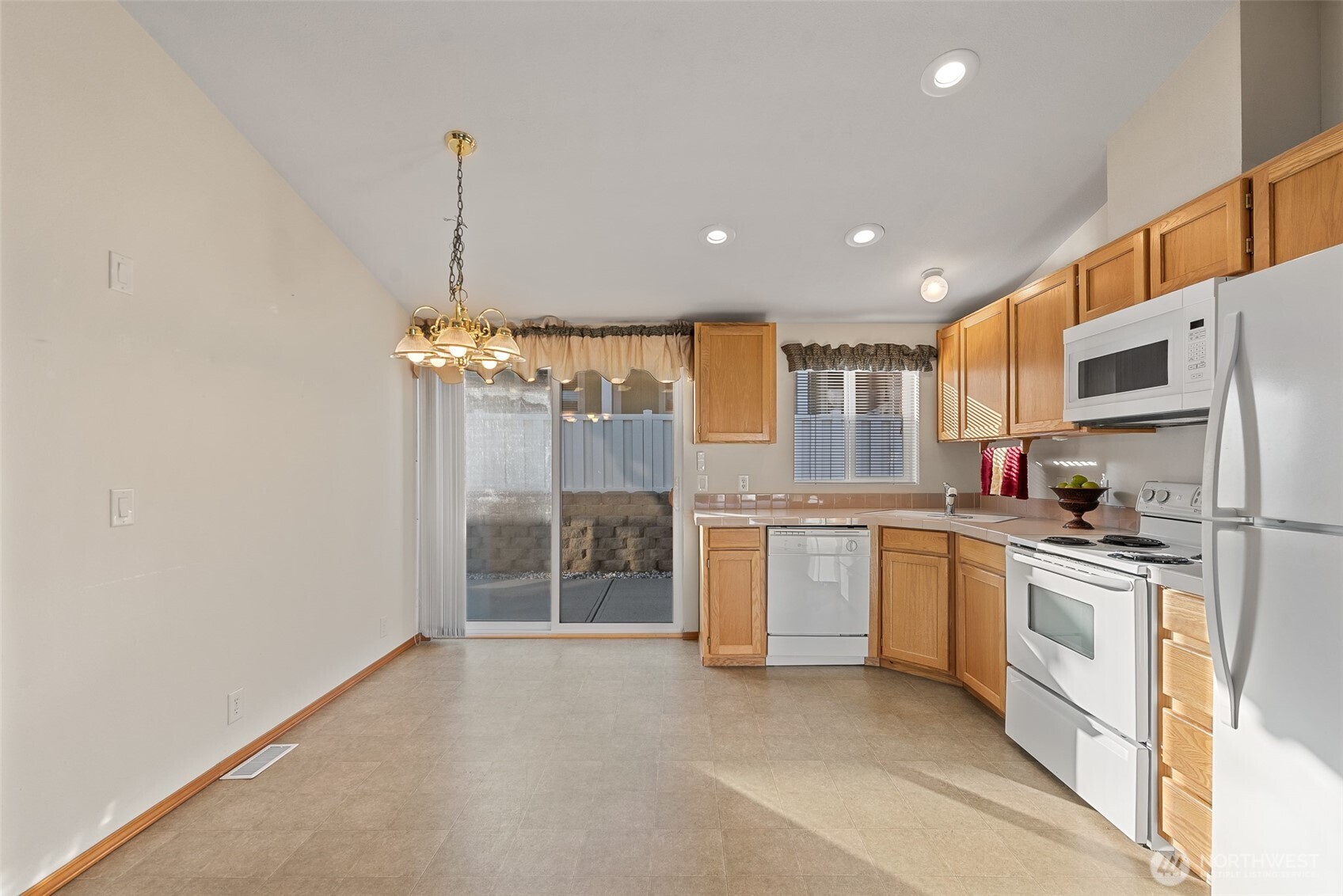 1232 Woods Street Wenatchee, WA 98801 - Photo 19 of 31 a kitchen with white cabinets and stainless steel appliances