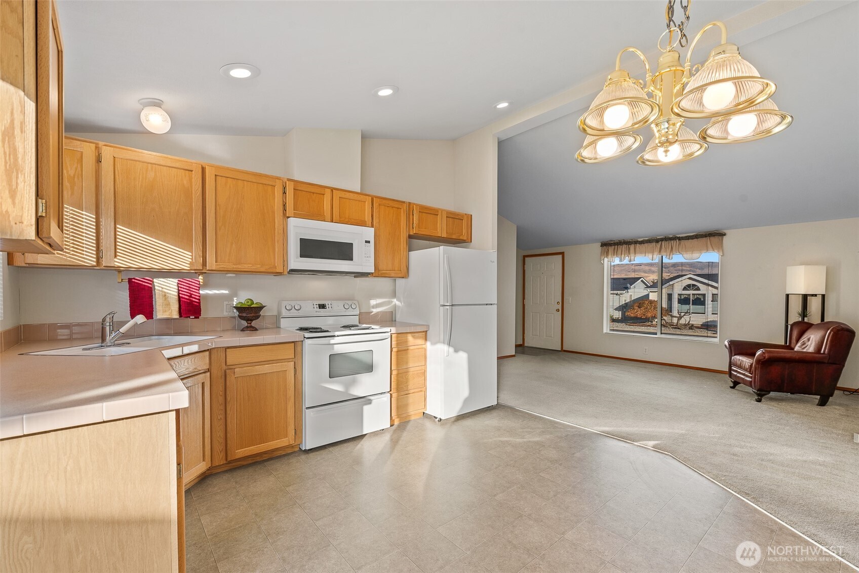 1232 Woods Street Wenatchee, WA 98801 - Photo 20 of 31 a open kitchen with stainless steel appliances granite countertop a stove top oven a sink dishwasher and white cabinets with wooden floor