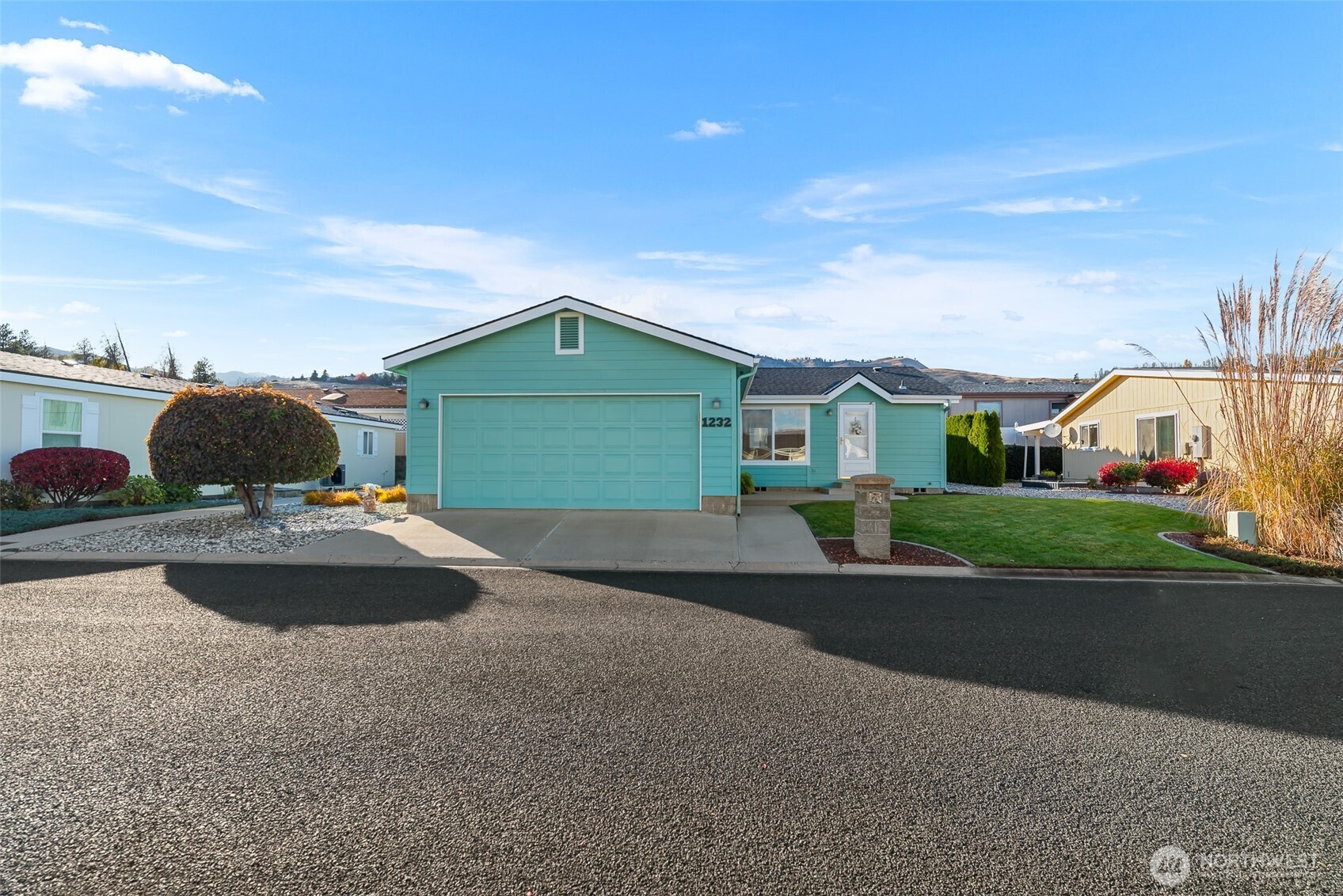 1232 Woods Street Wenatchee, WA 98801 - Photo 2 of 31 a front view of a house with cars parked