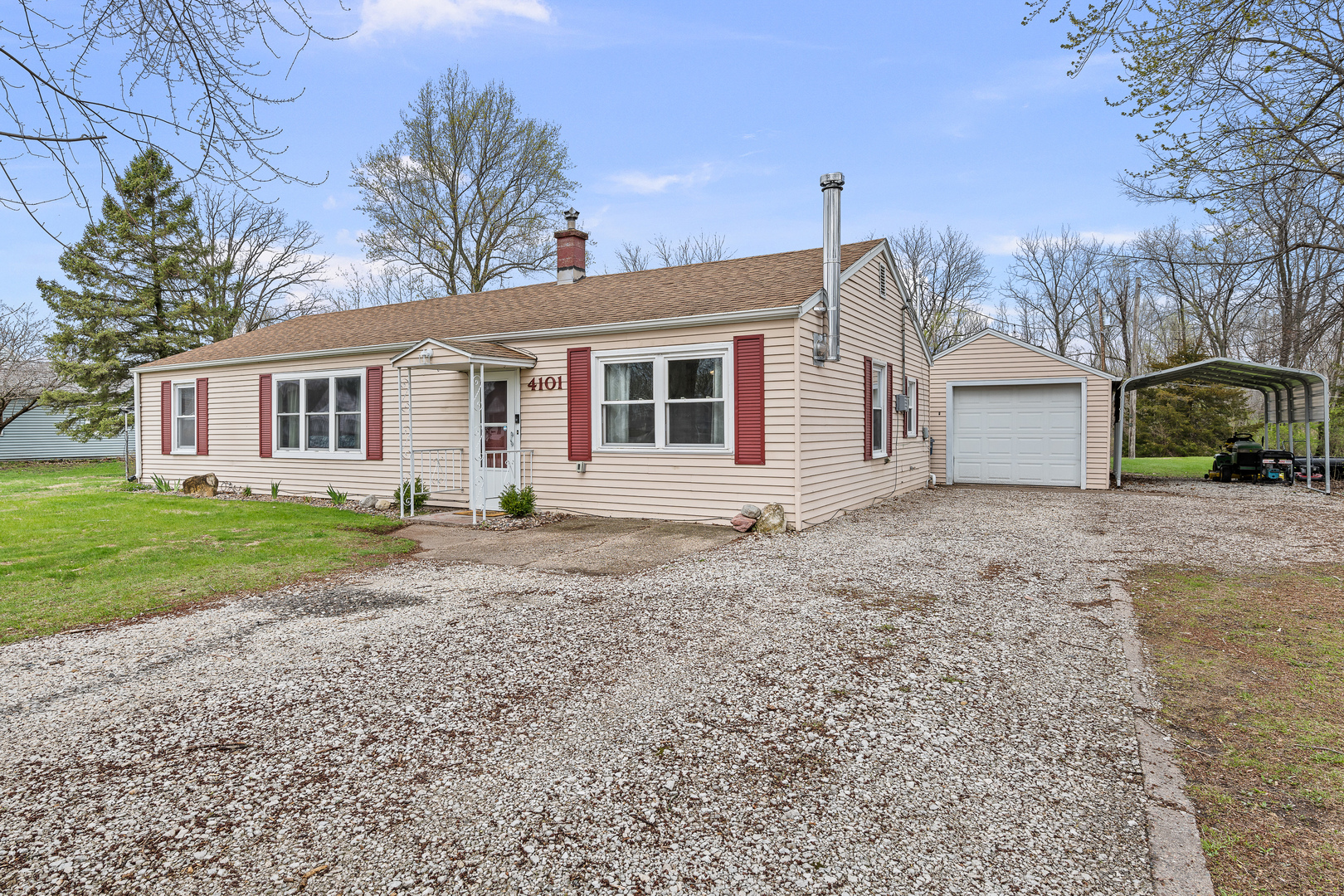 a view of a house with a yard and large tree