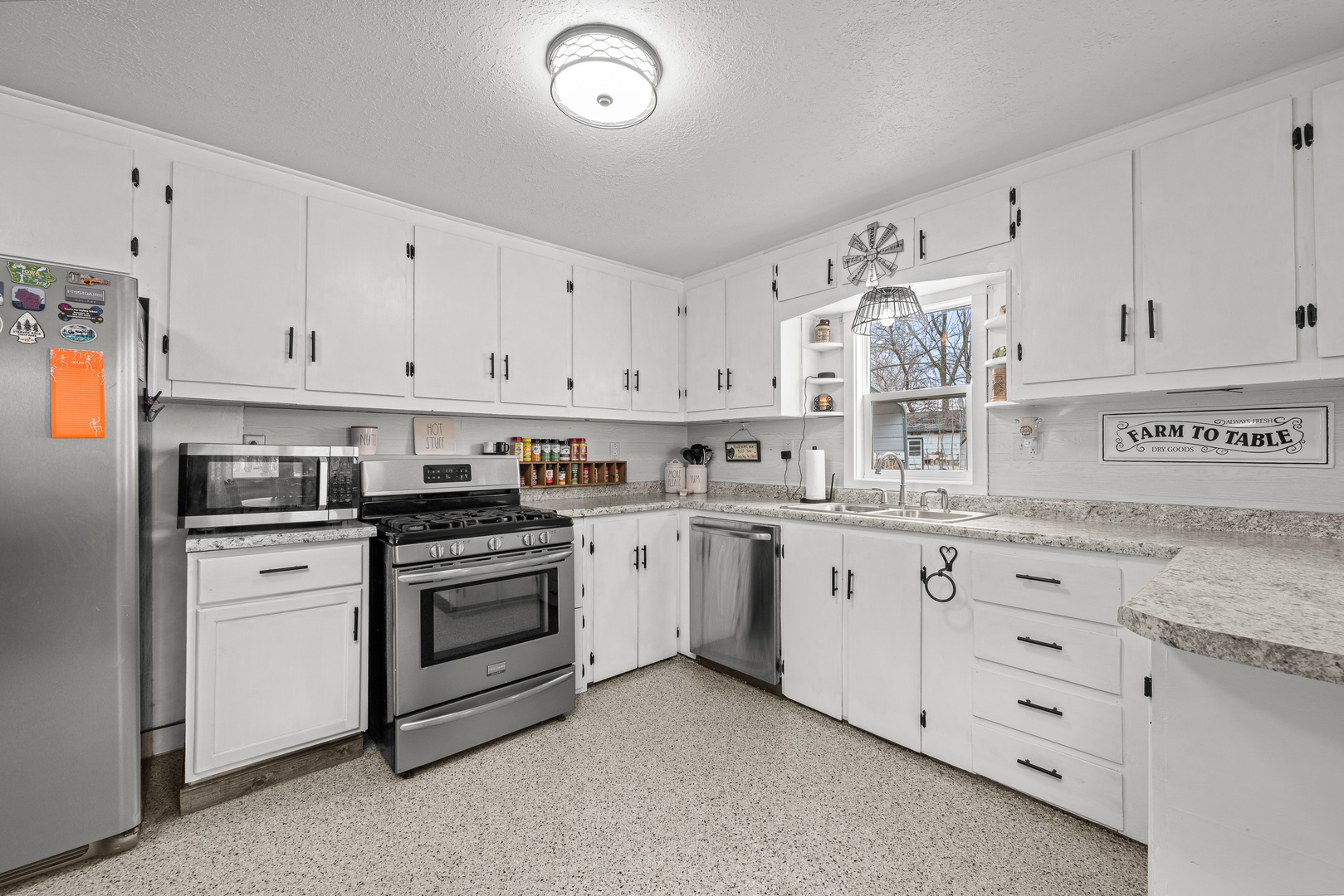 4101 5th Avenue East Moline, IL 61244 - Photo 24 of 36 a kitchen with granite countertop white cabinets and white appliances