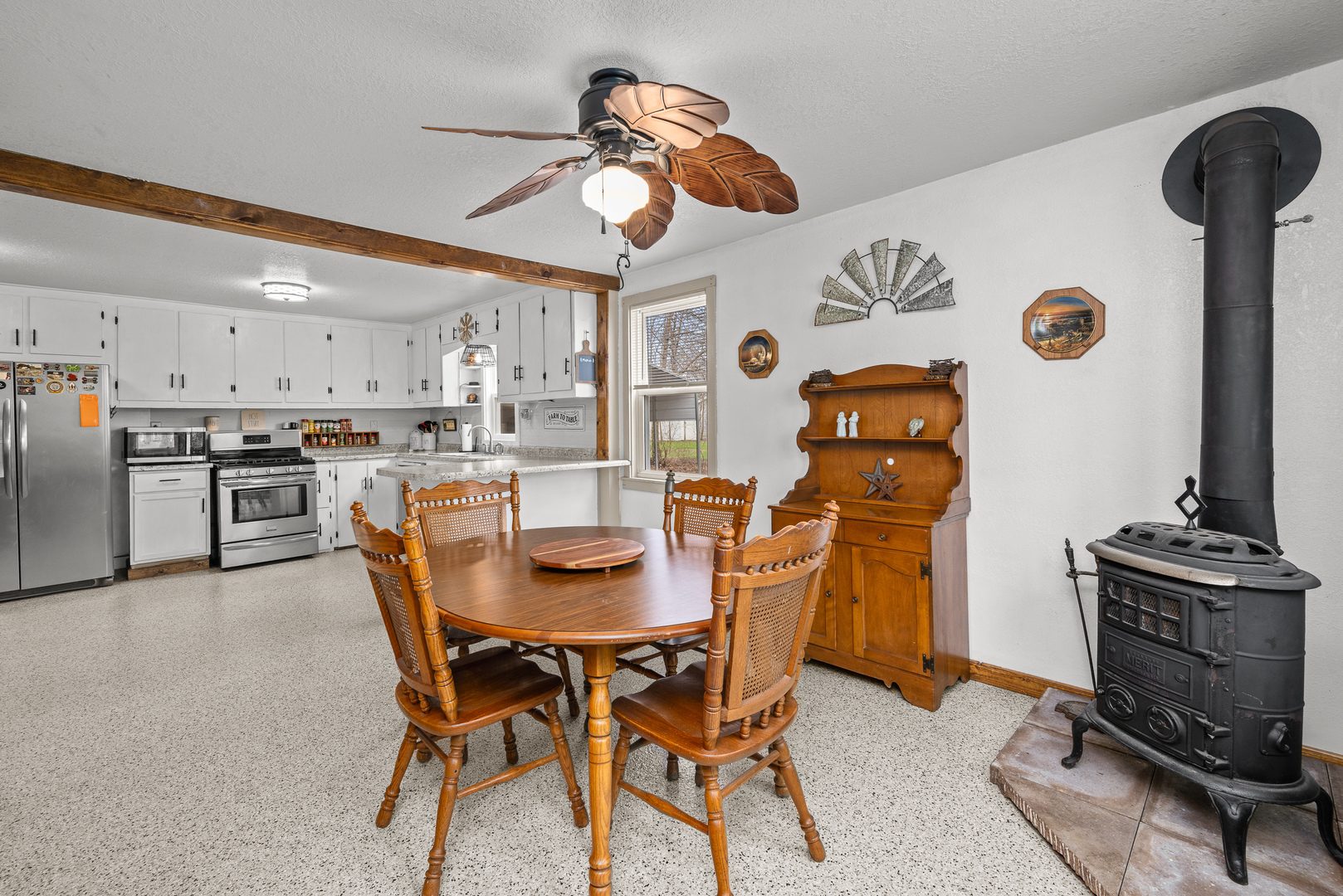 4101 5th Avenue East Moline, IL 61244 - Photo 28 of 36 a dining room with a kitchen island a stove and a refrigerator