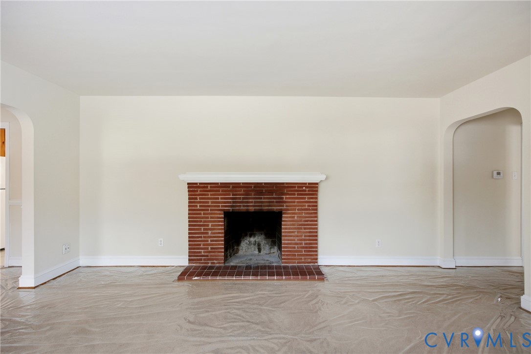3225 Lakewood Road Glen Allen, VA 23060 - Photo 6 of 43 a view of an empty room with wooden floor and a fireplace