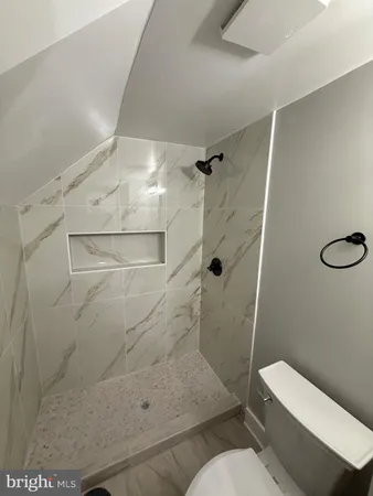 a bathroom with a toilet and a shower