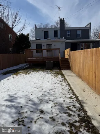 a view of a house with wooden fence