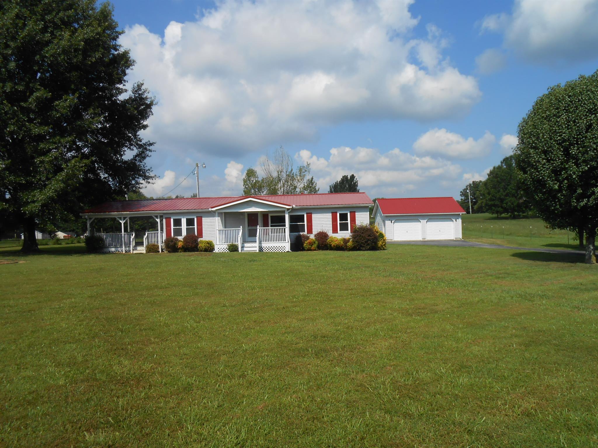 a front view of house with outdoor space and trees