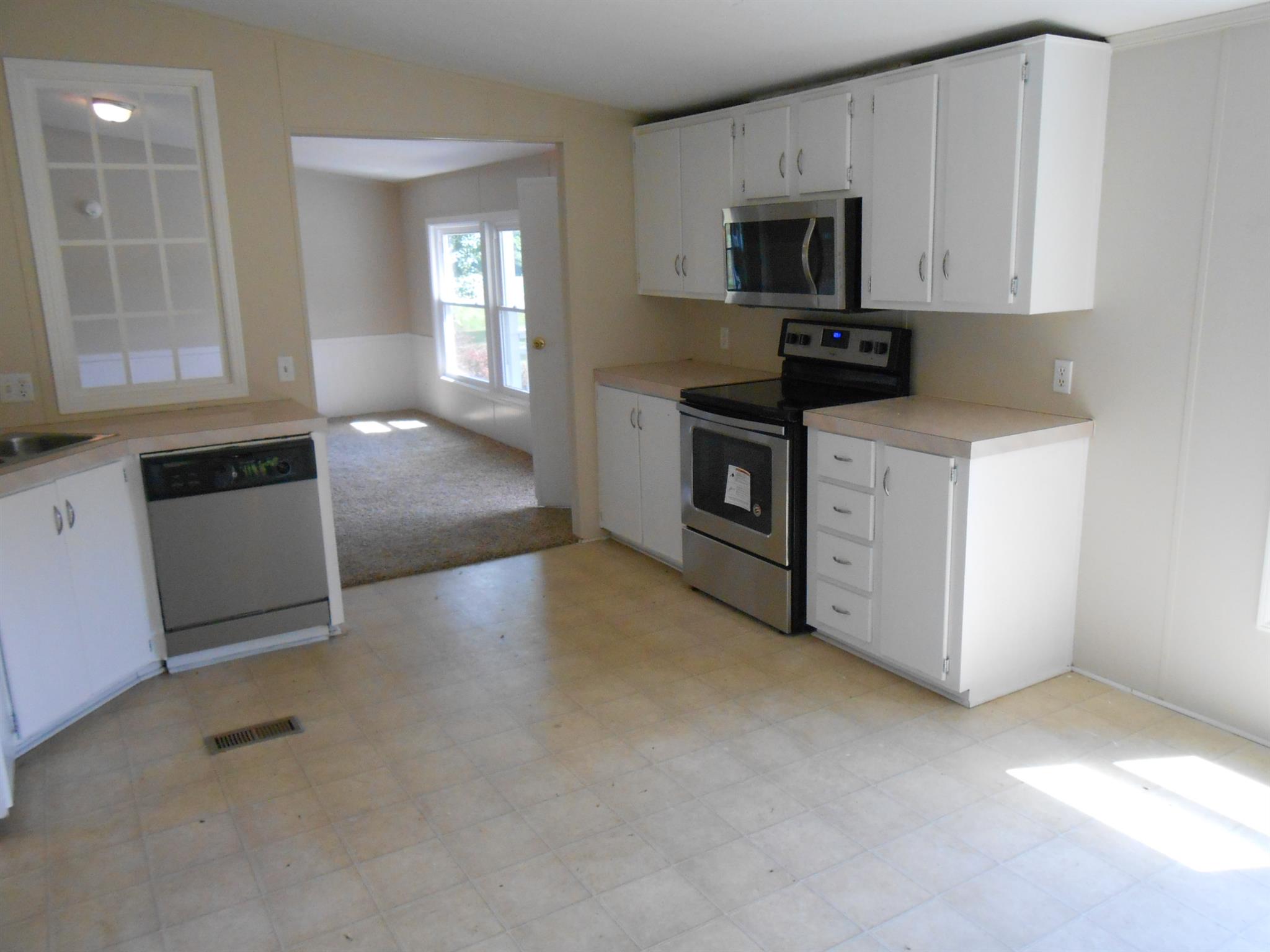 1225 Mt Vernon Road Bethpage, TN 37022 - Photo 9 of 15 a living room with stainless steel appliances granite countertop a stove a sink and a microwave