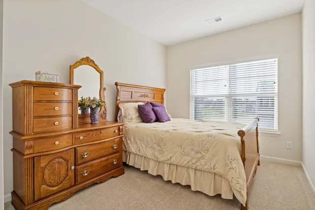 a bedroom with a bed and with furniture