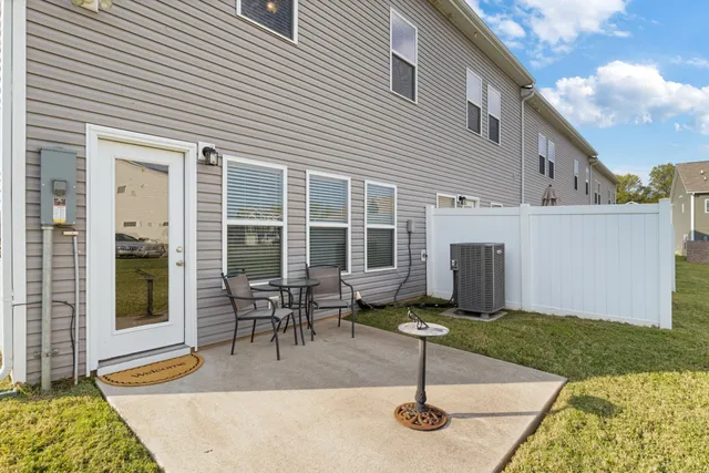 a view of a house with backyard porch and sitting area