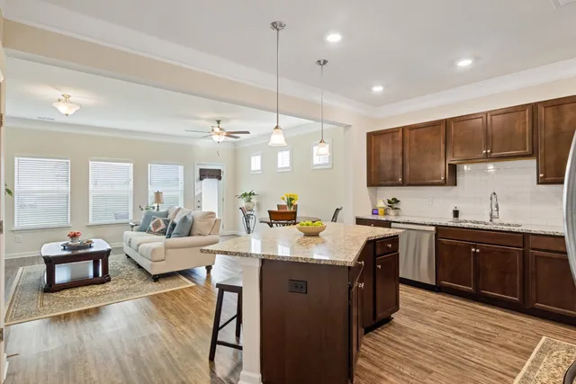 a large kitchen with lots of counter space and wooden floor
