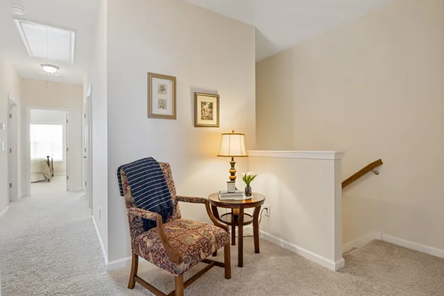 a living room with furniture and a chair