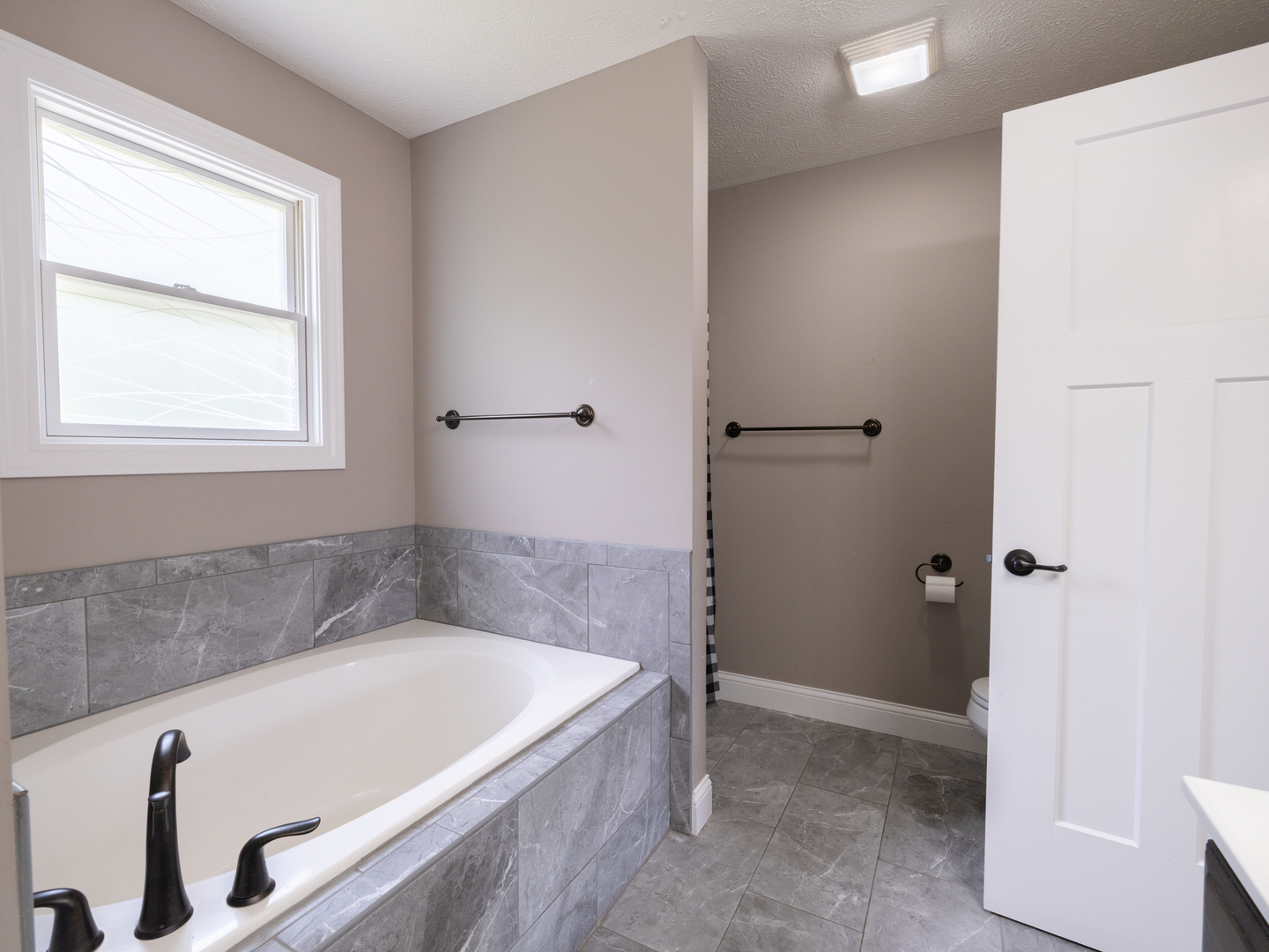 25 Greenbriar Road Mackinaw, IL 61755 - Photo 31 of 51 a bath tub sitting in a bathroom next to a window