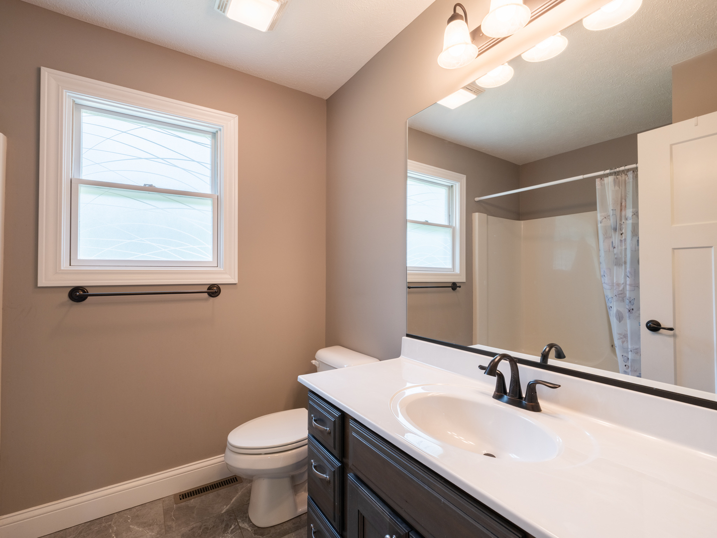 25 Greenbriar Road Mackinaw, IL 61755 - Photo 43 of 51 a bathroom with a sink a toilet and mirror