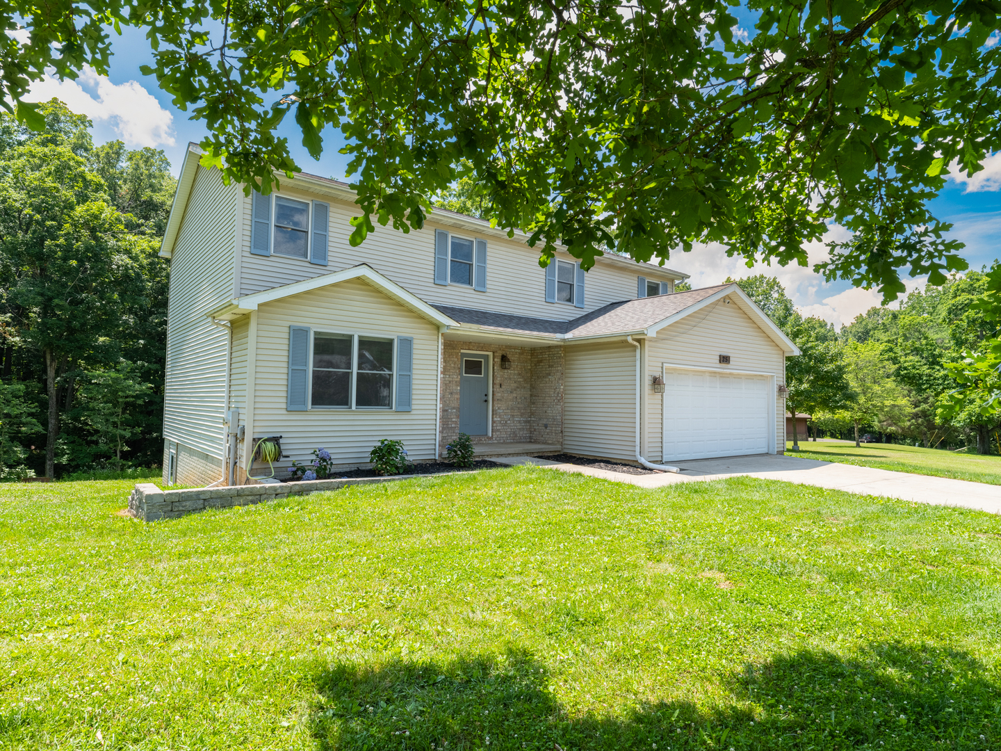 25 Greenbriar Road Mackinaw, IL 61755 - Photo 49 of 51 a front view of a house with a yard and garage