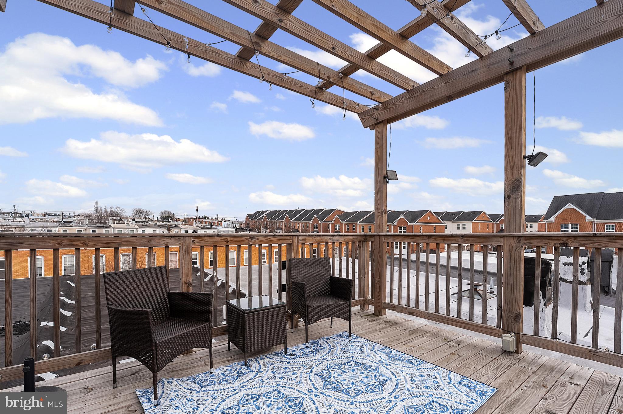 632 South Macon Street Baltimore, MD 21224 - Photo 12 of 20 a view of a balcony with wooden floor