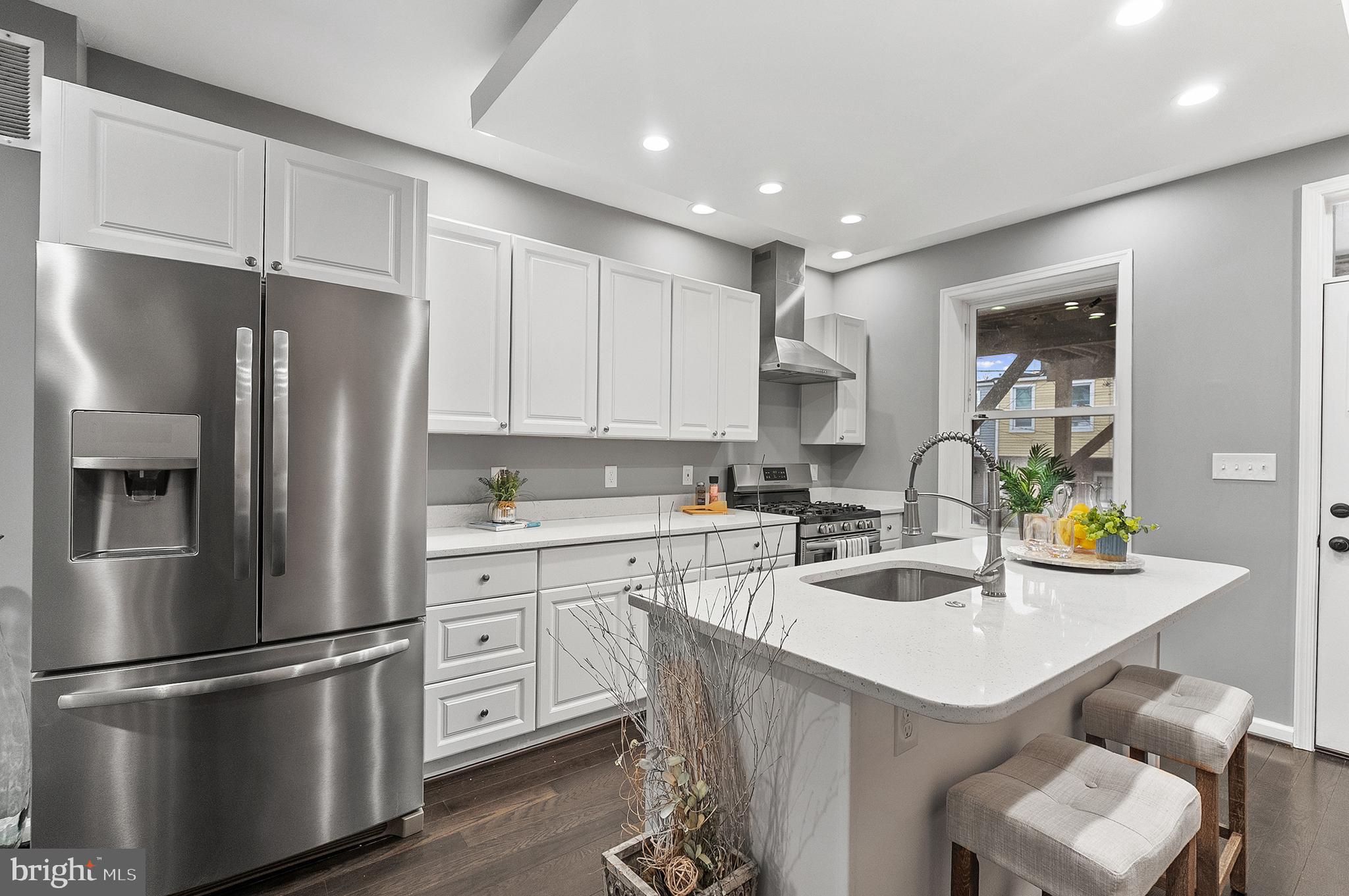 632 South Macon Street Baltimore, MD 21224 - Photo 4 of 20 a kitchen with a sink stainless steel appliances and refrigerator