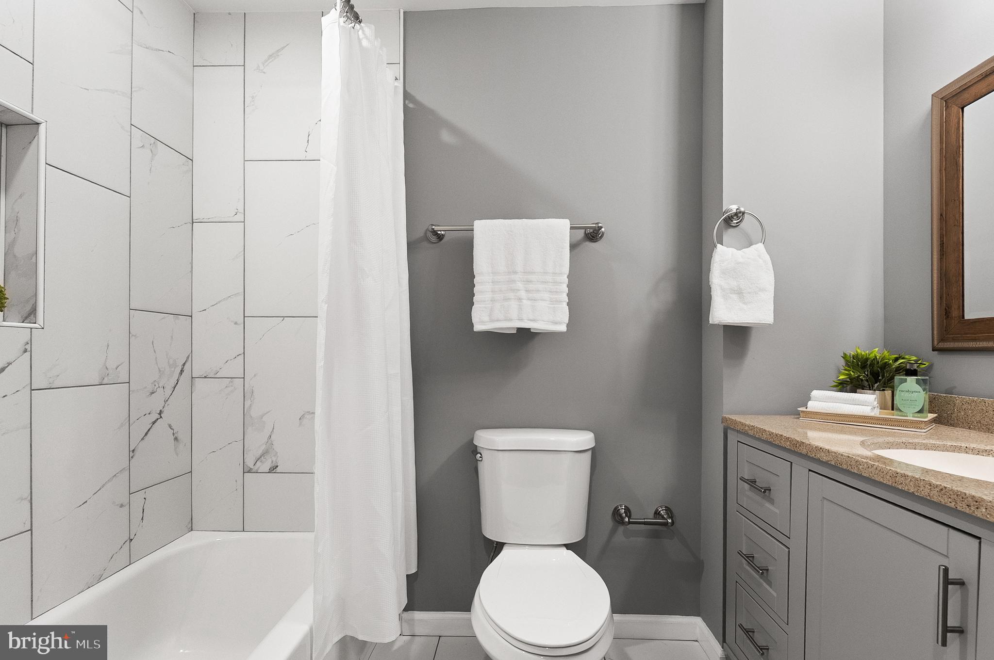632 South Macon Street Baltimore, MD 21224 - Photo 7 of 20 a bathroom with a sink a toilet and shower