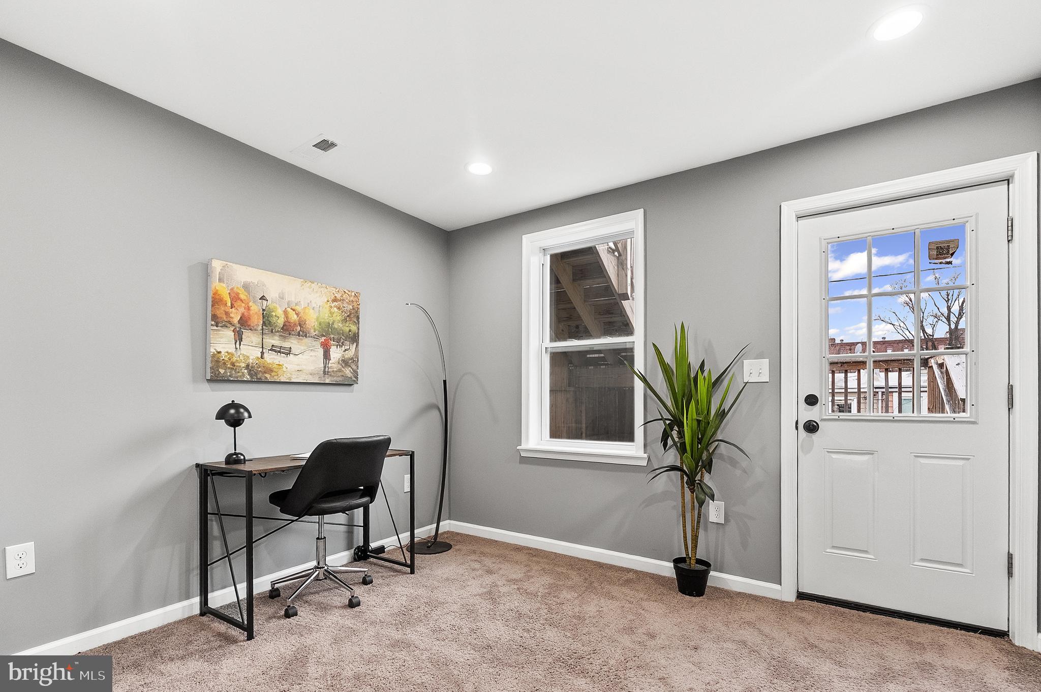 632 South Macon Street Baltimore, MD 21224 - Photo 8 of 20 a view of a workspace with a window and chair in a room