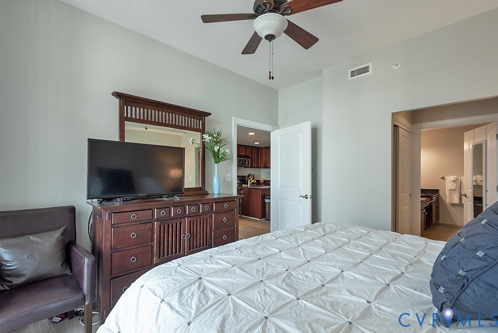 1101 Haxall Point, Unit 703 Richmond, VA 23219 - Photo 15 of 34 a bedroom with a bed and a flat screen tv