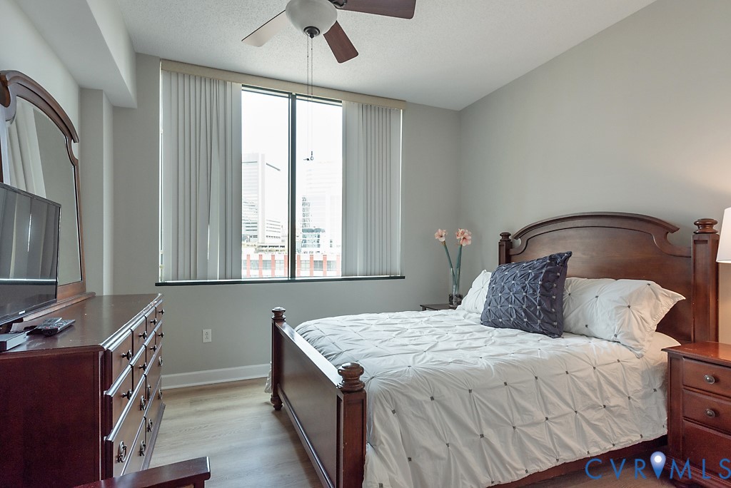 1101 Haxall Point, Unit 703 Richmond, VA 23219 - Photo 20 of 34 a bedroom with a bed and a chandelier