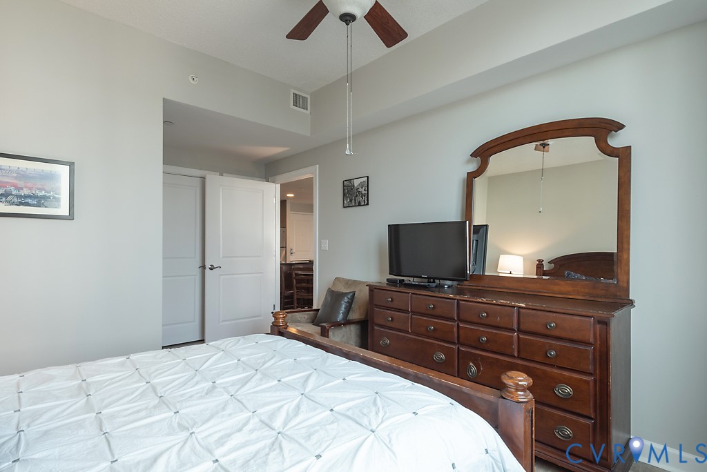 1101 Haxall Point, Unit 703 Richmond, VA 23219 - Photo 21 of 34 a bedroom with a bed and a flat screen tv