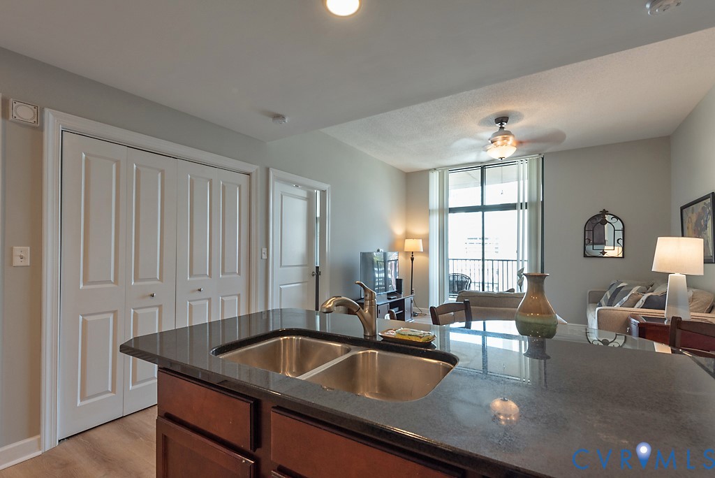 1101 Haxall Point, Unit 703 Richmond, VA 23219 - Photo 7 of 34 a kitchen with a sink and white cabinets