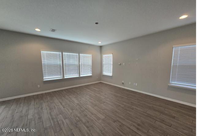8182 Dancing Fox Street Jacksonville, FL 32222 - Photo 5 of 11 a view of an empty room with wooden floor and a window