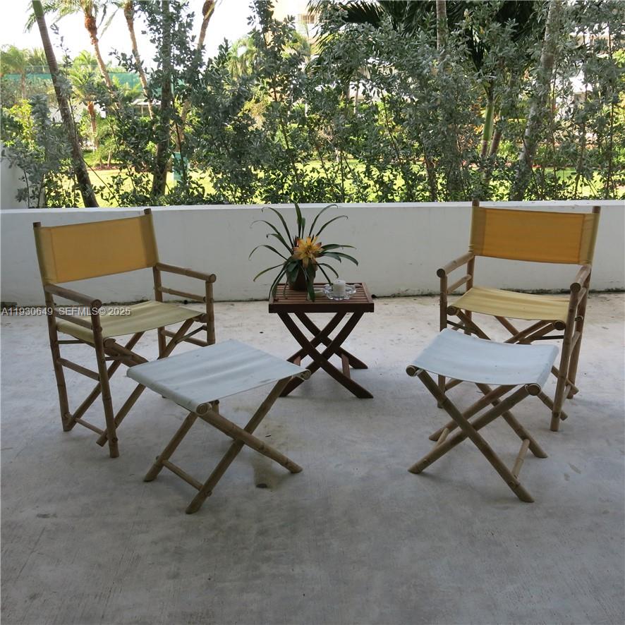 an outdoor sitting area with couch and a fireplace