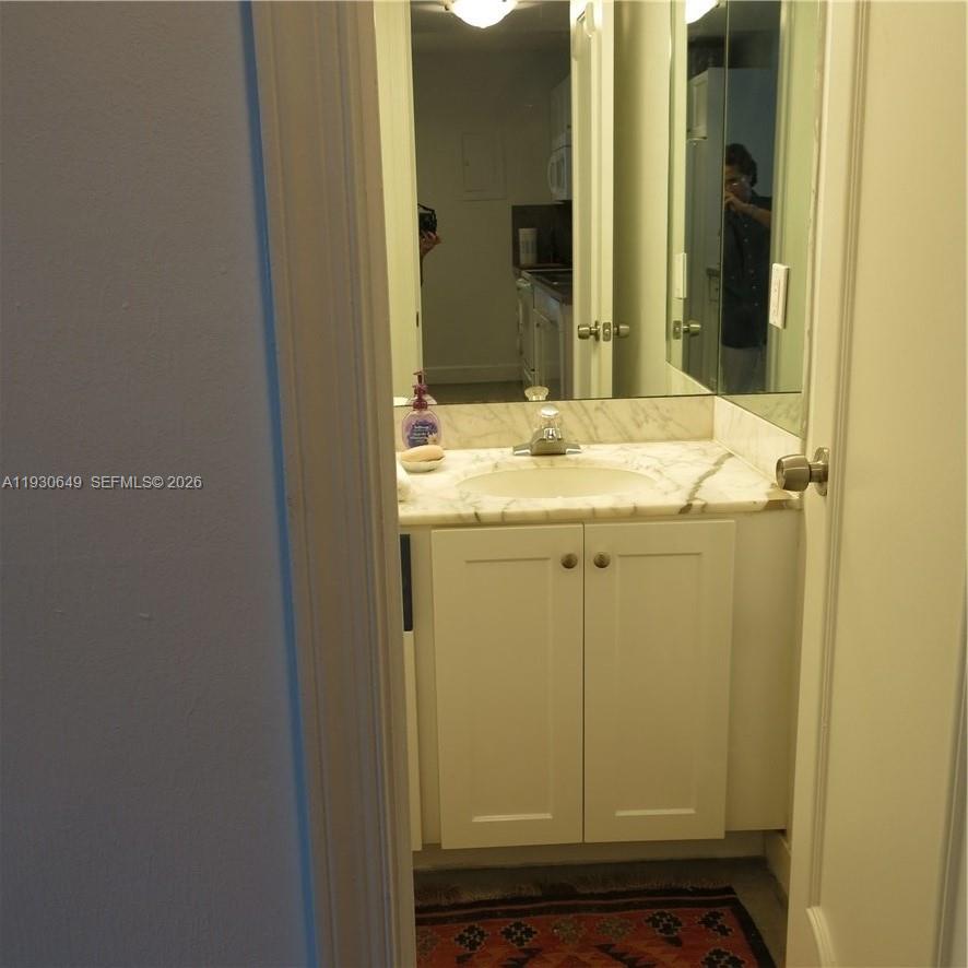 199 Ocean Ln Drive, Unit 102 Key Biscayne, FL 33149 - Photo 11 of 26 a bathroom with a sink and a mirror