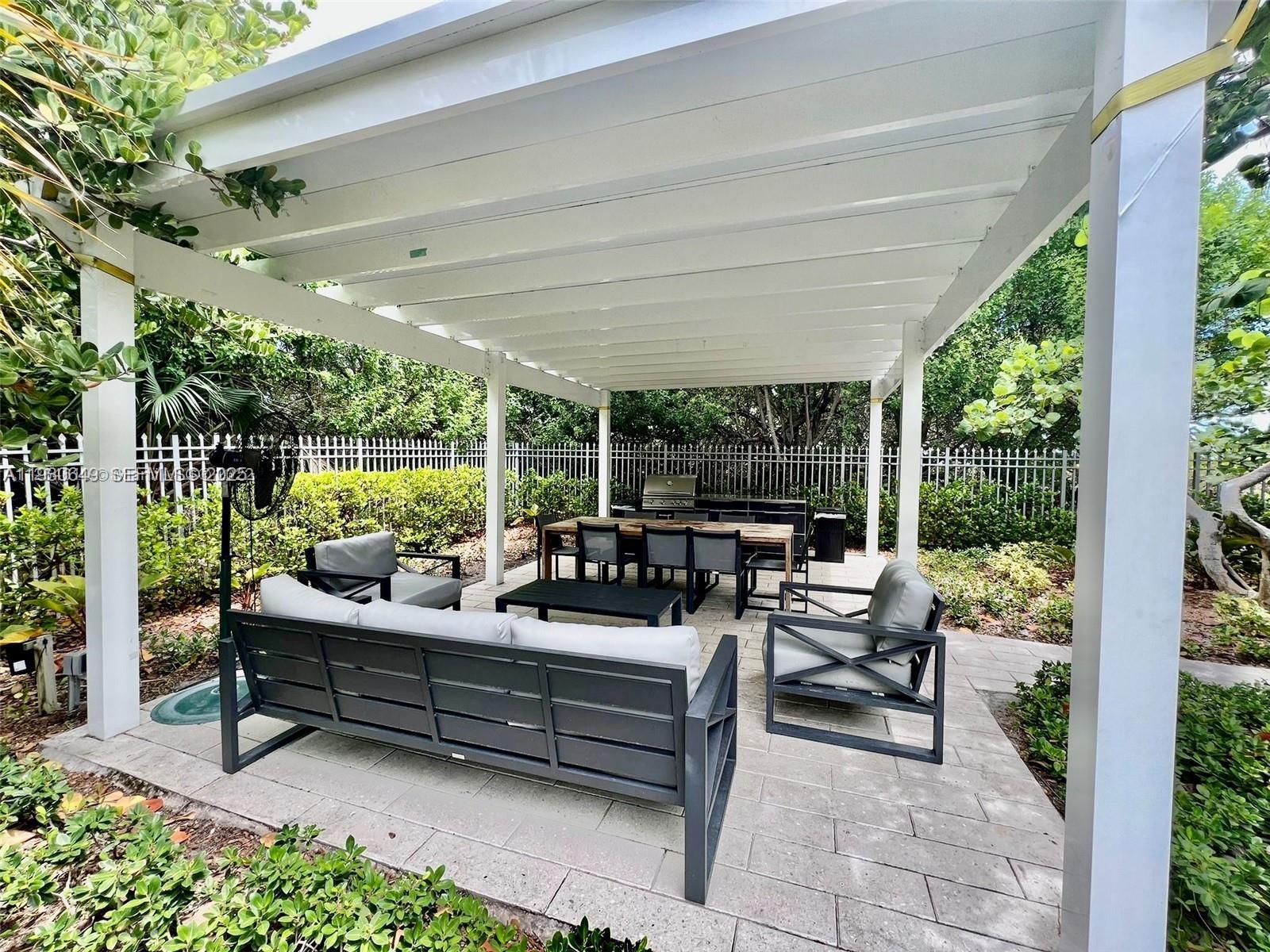 199 Ocean Ln Drive, Unit 102 Key Biscayne, FL 33149 - Photo 21 of 24 a outdoor living space with furniture and garden view