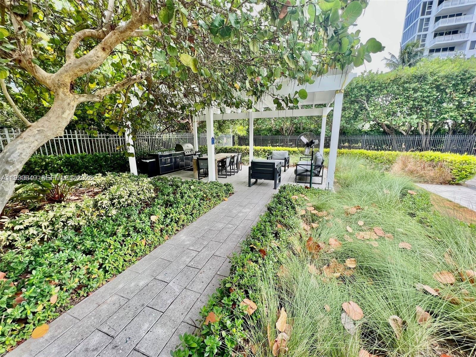 199 Ocean Ln Drive, Unit 102 Key Biscayne, FL 33149 - Photo 22 of 26 a view of a garden with patio