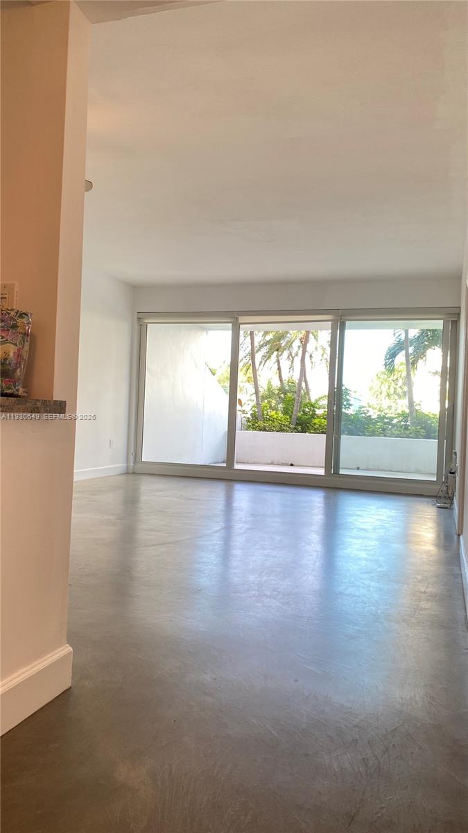 199 Ocean Ln Drive, Unit 102 Key Biscayne, FL 33149 - Photo 24 of 26 a view of a livingroom with wooden floor and a floor to ceiling window
