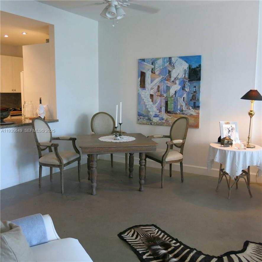 199 Ocean Ln Drive, Unit 102 Key Biscayne, FL 33149 - Photo 6 of 24 a dining room with furniture and a painting