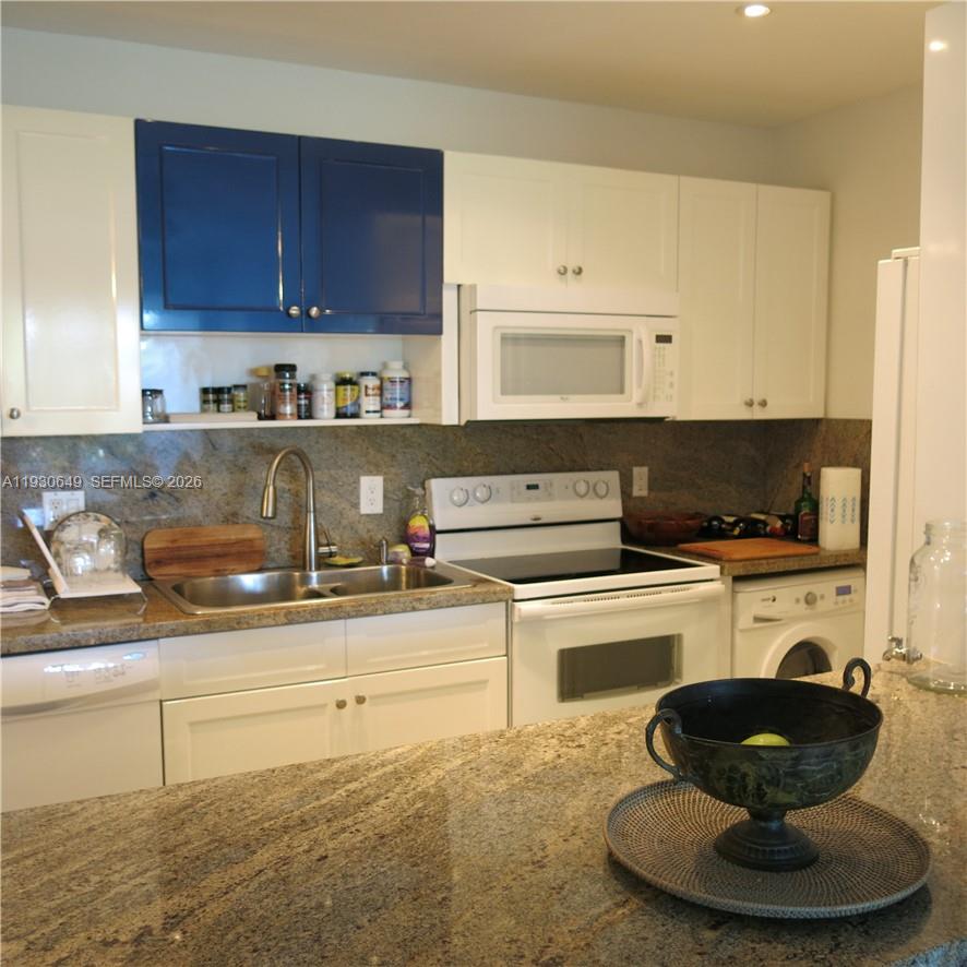 199 Ocean Ln Drive, Unit 102 Key Biscayne, FL 33149 - Photo 9 of 26 a kitchen with a stove and cabinets