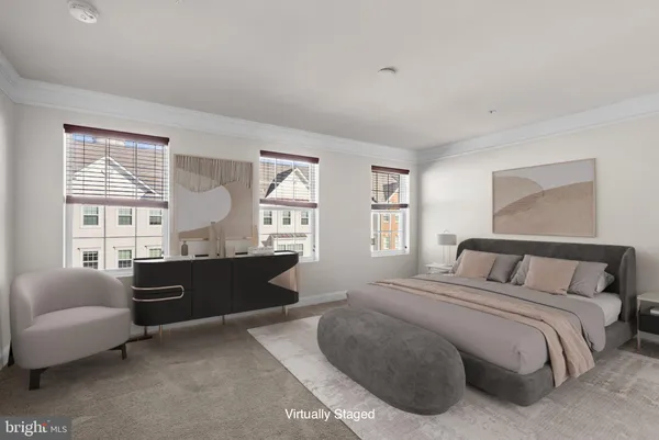 a bedroom with a bed and a couch next to a window