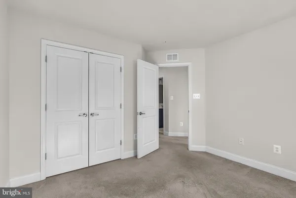 a view of an empty room and closet area
