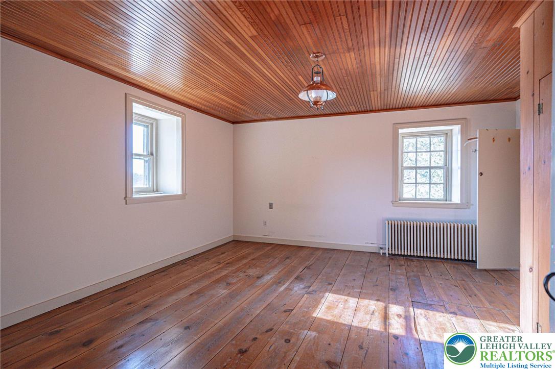 621 Nursery Road Kempton, PA 19529 - Photo 31 of 64 an empty room with wooden floor and windows