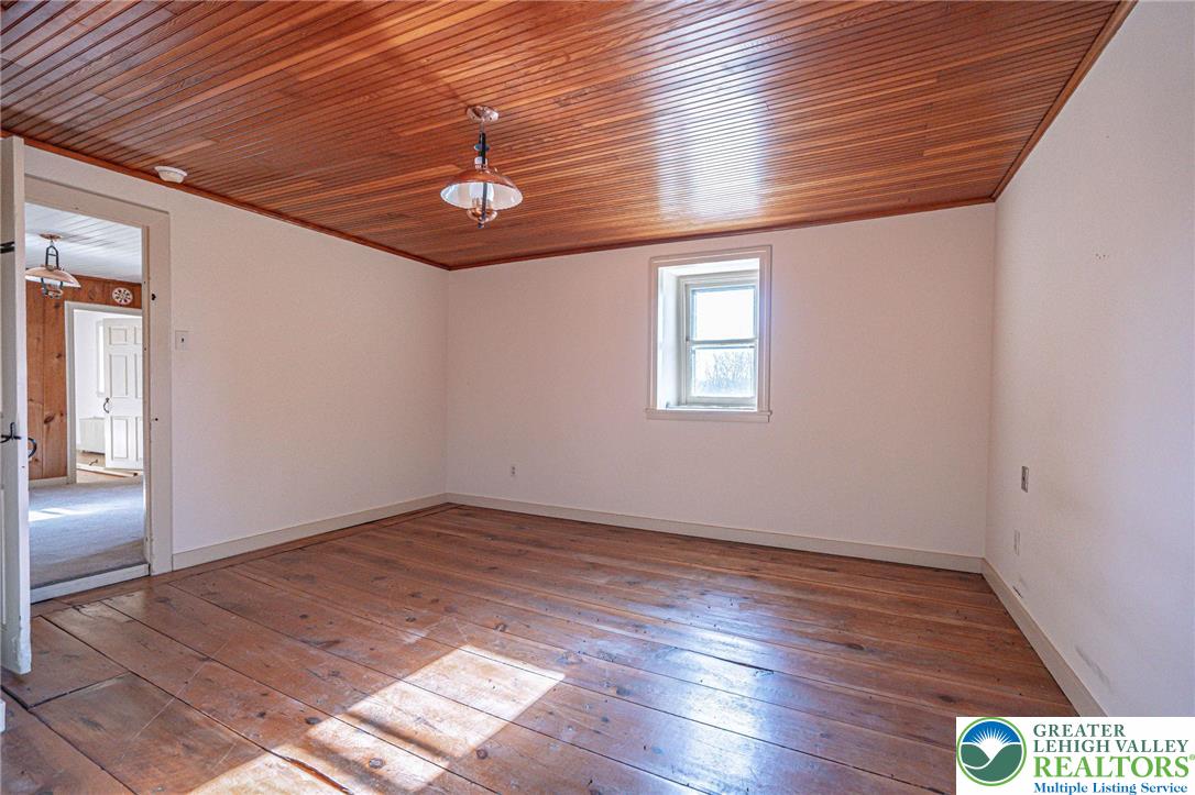 621 Nursery Road Kempton, PA 19529 - Photo 32 of 64 an empty room with wooden floor ceiling fan and windows