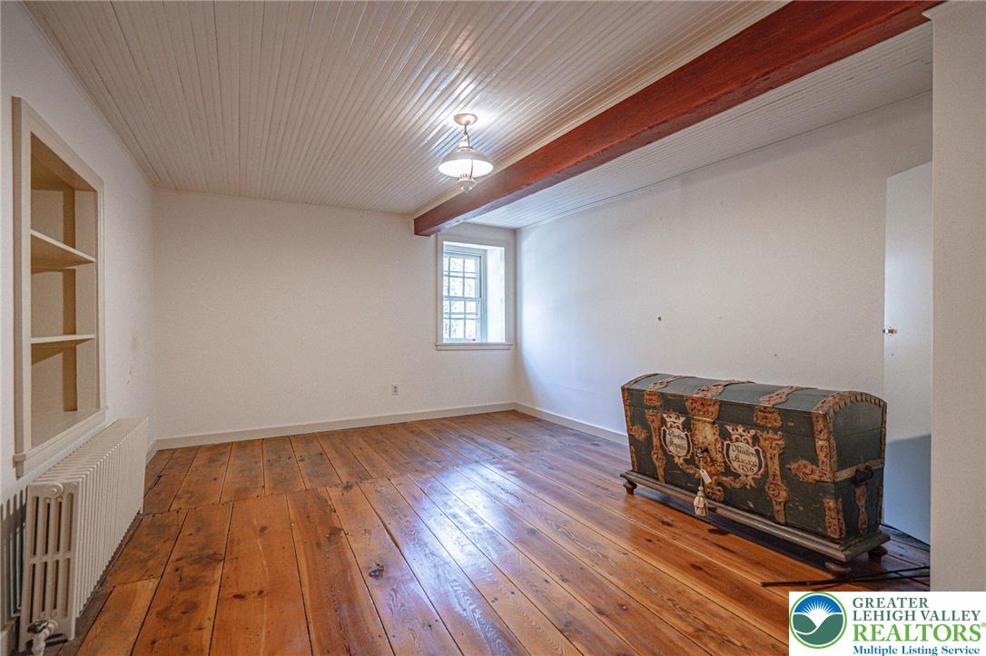 621 Nursery Road Kempton, PA 19529 - Photo 37 of 64 a view of an empty room with wooden floor and a window