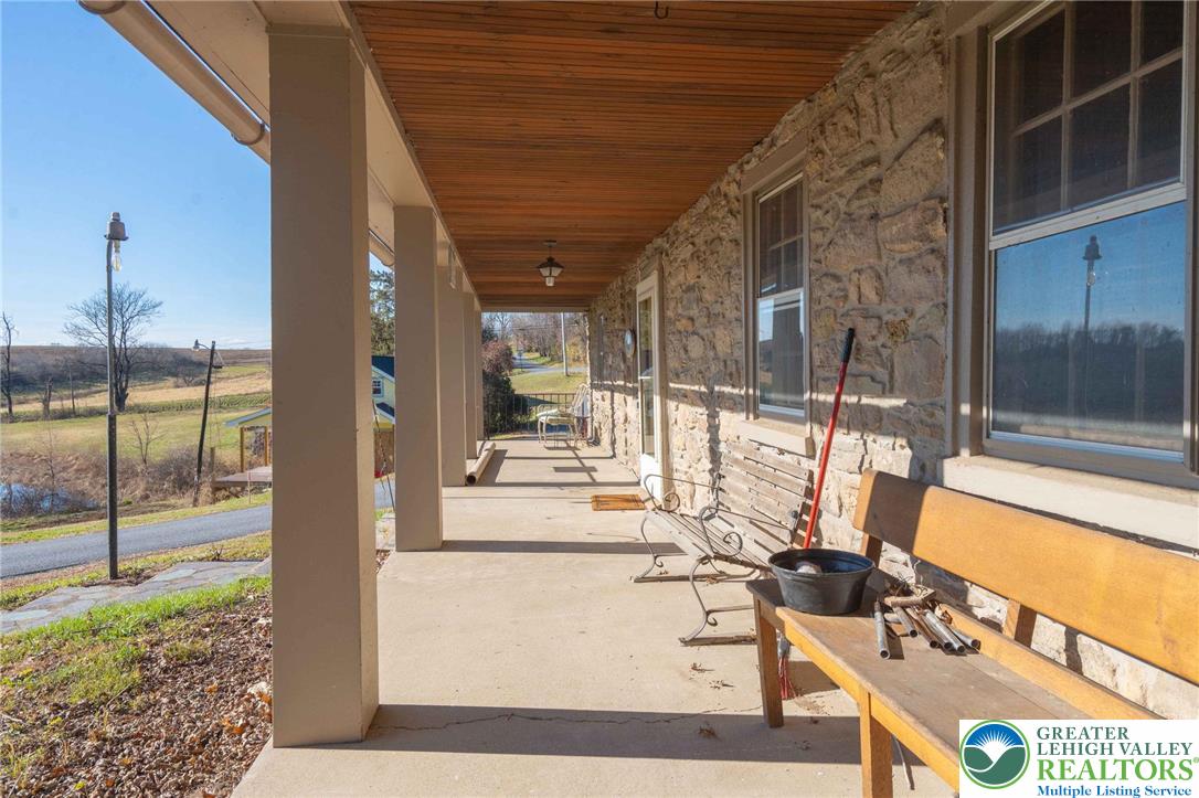 621 Nursery Road Kempton, PA 19529 - Photo 10 of 64 a view of a patio with a dining table chairs and iron gate