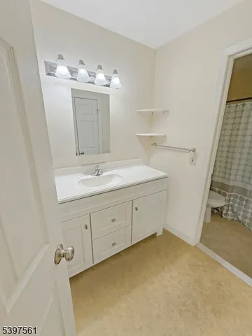 a bathroom with a sink vanity and mirror