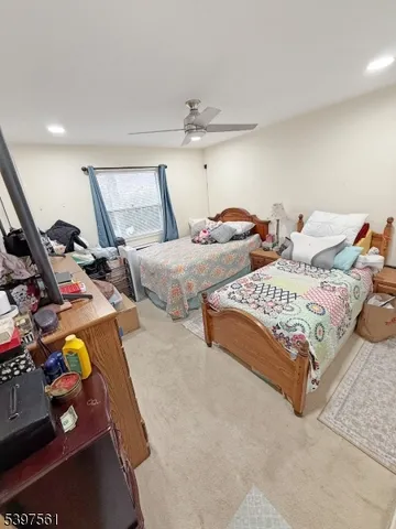 a bedroom with two beds and a window