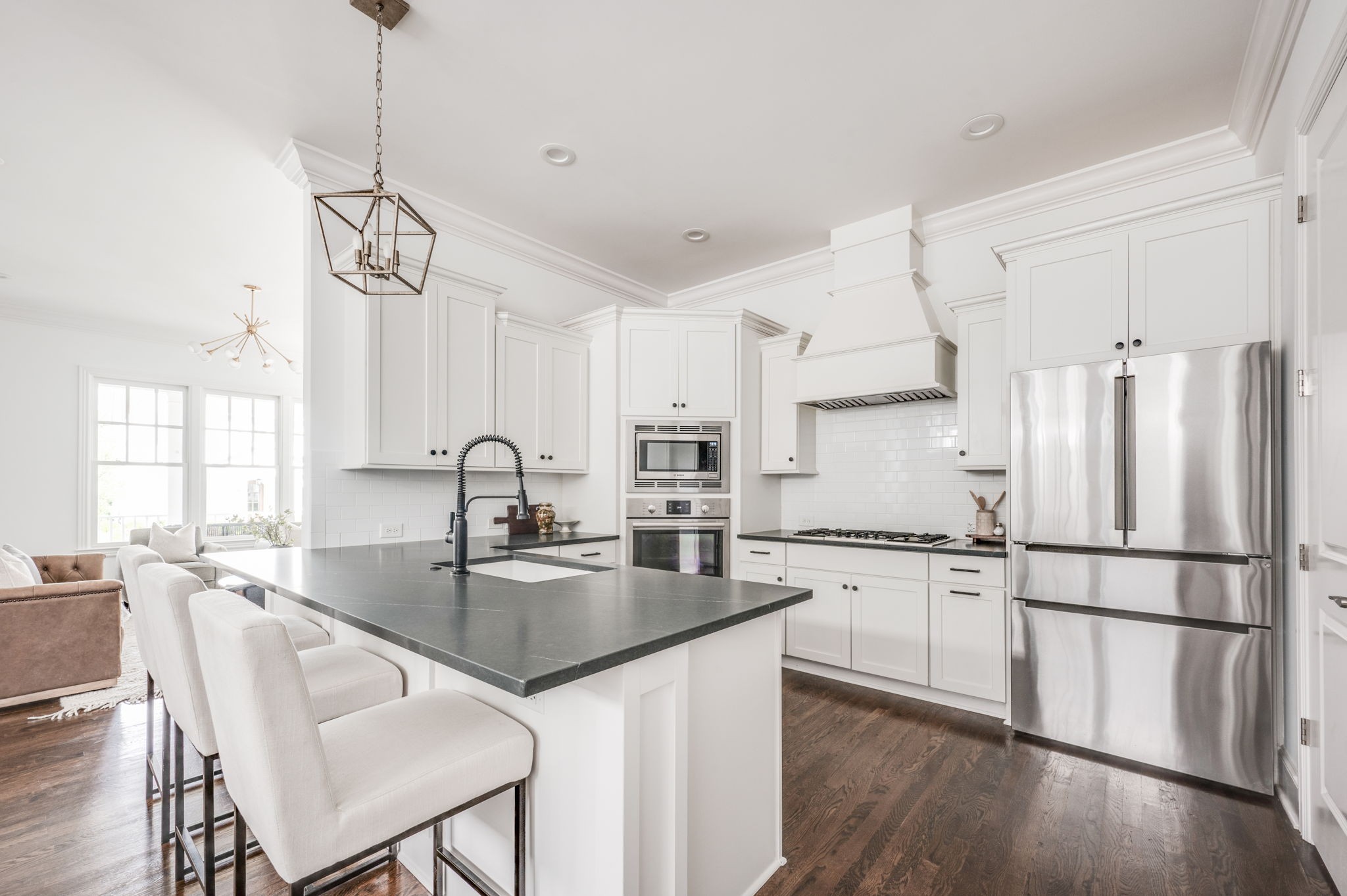 5144 Donovan Street Franklin, TN 37064 - Photo 22 of 52 a kitchen with stainless steel appliances granite countertop a refrigerator a sink dishwasher a stove and white cabinets with wooden floor