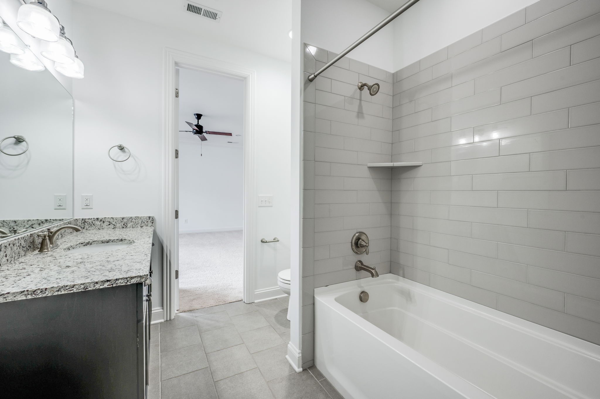 5144 Donovan Street Franklin, TN 37064 - Photo 39 of 52 a bathroom with a granite countertop bathtub shower sink and mirror