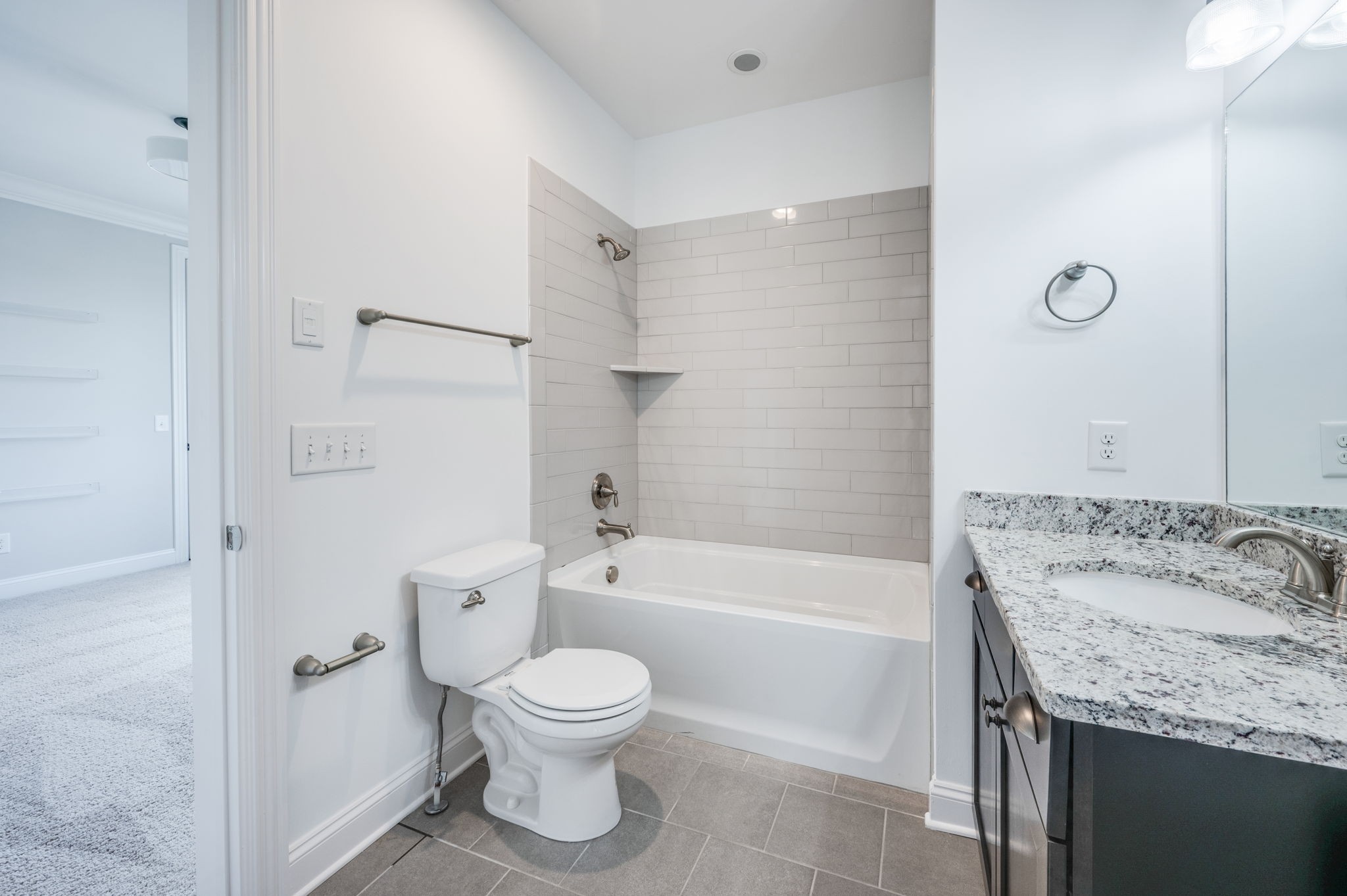 5144 Donovan Street Franklin, TN 37064 - Photo 46 of 52 a bathroom with a granite countertop toilet a sink and a bathtub